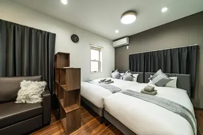 a bedroom with two beds and a couch at 88, Kanegafuchi 3A, Entire house for rent, \u9418\u30f6\u6df53A in Tokyo