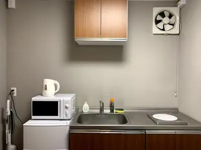 a kitchen with a sink and a microwave at \u30a2\u30f3\u30c9\u30b9\u30c6\u30a4\u30ce\u30dc\u30c3\u30c1\u30db\u30c6\u30eb201 in Tokyo