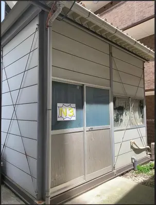 a garage with a door with a logo on it at \u30a2\u30f3\u30c9\u30b9\u30c6\u30a4\u30ce\u30dc\u30c3\u30c1\u30db\u30c6\u30ebn3 in Tokyo
