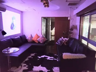 a purple living room with a couch and a table at Casa Tokyo -Arakicho- in Tokyo