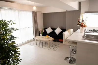 a kitchen and living room with a couch and a table at \u862d\u5712 Village Gotanda \u5c4b\u4e0a\u30ac\u30fc\u30c7\u30f3\u30c6\u30e9\u30b9\u4ed8\u304d in Tokyo
