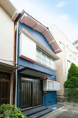 a blue building with a balcony on top of it at 49, Yotsugi 2, Entire house for rent, \u56db\u3064\u67282 in Tokyo