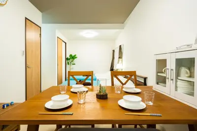 a dining room table with plates and glasses on it at 49, Yotsugi 2, Entire house for rent, \u56db\u3064\u67282 in Tokyo
