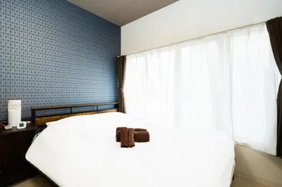 a bedroom with a white bed and a window at 49, Yotsugi 2, Entire house for rent, \u56db\u3064\u67282 in Tokyo