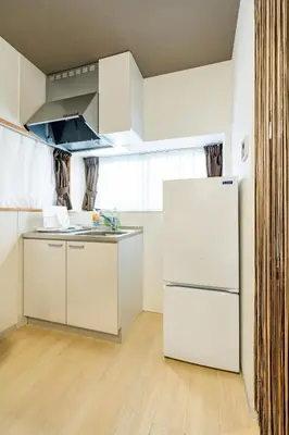 a kitchen with a white refrigerator in a room at 49, Yotsugi 2, Entire house for rent, \u56db\u3064\u67282 in Tokyo