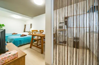 a room with a bed and a desk with a table at 49, Yotsugi 2, Entire house for rent, \u56db\u3064\u67282 in Tokyo