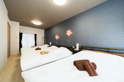 a bedroom with two beds with teddy bears on them at 49, Yotsugi 2, Entire house for rent, \u56db\u3064\u67282 in Tokyo