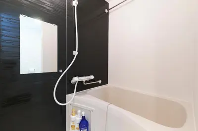 a bathroom with a bath tub and a sink at Sky Up Oshiage by Tranova in Tokyo