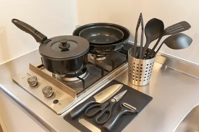 a stove with pots and pans and utensils on it at Sky Up Oshiage by Tranova in Tokyo
