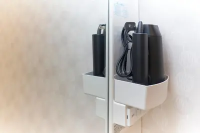 a wall mounted unit with black cords in it at Sky Up Oshiage by Tranova in Tokyo