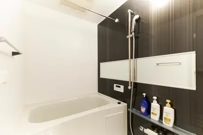 a bathroom with a sink and a bath tub at Frontier Comfort Kitaikebukuro by Tranova in Tokyo