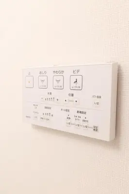 a white remote control attached to a white wall at Home Story in Tokyo Ueno&Uguisudani-小島ビル&東京屋語 in Tokyo