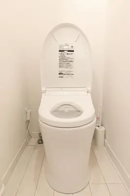 a white toilet with the lid up in a bathroom at Home Story in Tokyo Ueno&Uguisudani-小島ビル&東京屋語 in Tokyo