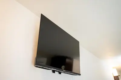 a flat screen tv hanging on a wall at Premier suite Baron Shinjuku West in Tokyo