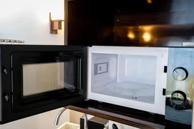 a microwave sitting on top of a table at Premier suite Baron Shinjuku West in Tokyo