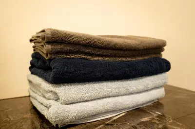 a stack of towels sitting on top of a table at Premier suite Baron Shinjuku West in Tokyo