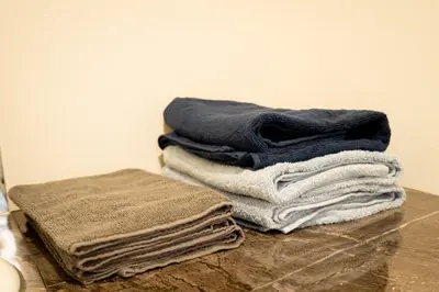 a stack of towels sitting on top of a counter at Premier suite Baron Shinjuku West in Tokyo