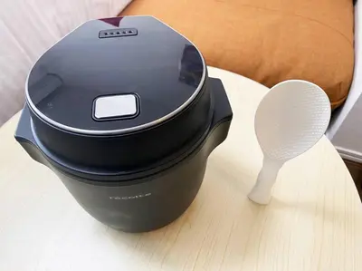a black pot sitting on a table with a whisk at Skytree & Asakusa in front! Newly built 202 in Tokyo