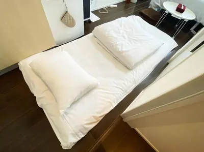 a bed with white pillows on it in a room at Skytree & Asakusa in front! Newly built 202 in Tokyo