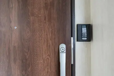 a door with a remote control next to a wooden door at Provence Hotel in Tokyo