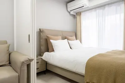 a bedroom with a large bed and a window at Provence Hotel in Tokyo