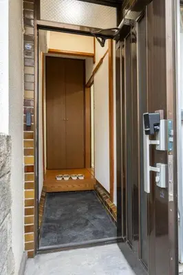 a hallway with a pair of shoes in a building at Golden House in Tokyo