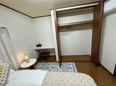 a bedroom with a bunk bed and a desk at Golden House in Tokyo