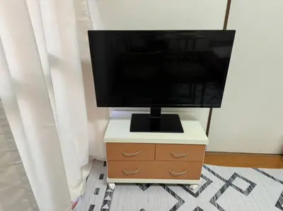 a television on top of a dresser in a room at Golden House in Tokyo