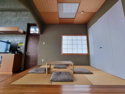 a room with a table and three mats on the floor at PRISM COURT HIRAI Room 801 in Tokyo