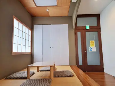 a room with a wooden table and a door at PRISM COURT HIRAI Room 801 in Tokyo
