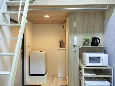 a tiny room with a microwave and a refrigerator at D22\u65b0\u5bbf\u6700\u4e2d\u5fc3 \u4e24\u5ba4 \u65b0\u5927\u4e45\u4fdd\u7ad95\u5206-2 rooms Shinjuku center 5 mins to ST Max 4P \u65b0\u5bbf \u6d89\u8c37 \u8868\u53c2\u9053 \u6c60\u888b \u4e0a\u91ce \u4ee3\u4ee3\u6728 \u94f6\u5ea7 \u539f\u5bbf in Tokyo