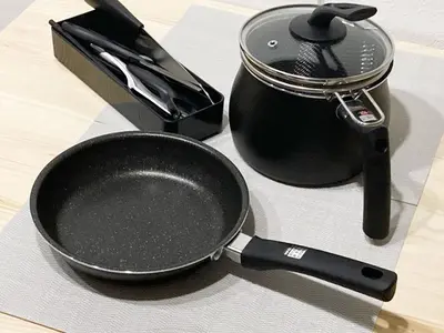 a frying pan sitting next to a pot on a table at Akariya Asakusa in Tokyo