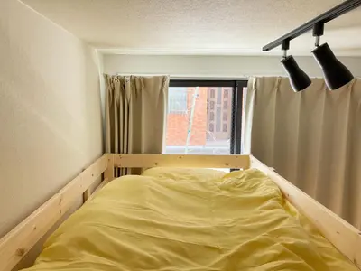 a bed in a room with a window at Akariya Asakusa in Tokyo
