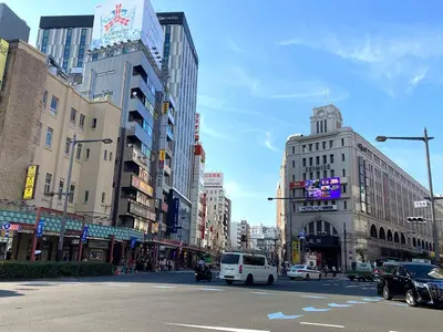 a busy city street with buildings and cars on the road at Akariya Asakusa in Tokyo
