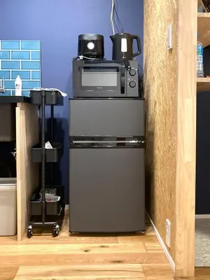 a microwave sitting on top of a refrigerator at Akariya Asakusa in Tokyo