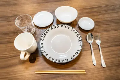 a table with a plate and utensils on it at 84-1, Shiomi 101, Entire room for rent, \u6f6e\u898bB101 in Tokyo