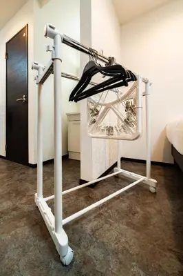 a clothes rack in a room with a bed at 84-1, Shiomi 101, Entire room for rent, \u6f6e\u898bB101 in Tokyo