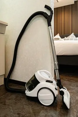 a vacuum cleaner on the floor next to a bed at 84-1, Shiomi 101, Entire room for rent, \u6f6e\u898bB101 in Tokyo