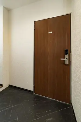 a large wooden door in a room with a tile floor at 84-2, Shiomi 102, Entire room for rent, \u6f6e\u898bB102 in Tokyo