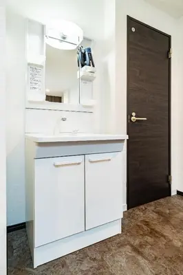 a white kitchen with a sink and a door at 84-2, Shiomi 102, Entire room for rent, \u6f6e\u898bB102 in Tokyo
