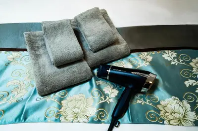 a hair dryer and two towels on a table at 84-2, Shiomi 102, Entire room for rent, \u6f6e\u898bB102 in Tokyo