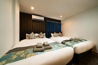 two beds in a hotel room with two bedsskirts at 84-4, Shiomi 202, Entire room for rent, \u6f6e\u898bB202 in Tokyo