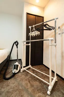 a room with a treadmill in front of a bed at 84-4, Shiomi 202, Entire room for rent, \u6f6e\u898bB202 in Tokyo