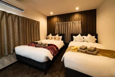 two beds in a hotel room withskirts at 84-4, Shiomi 202, Entire room for rent, \u6f6e\u898bB202 in Tokyo