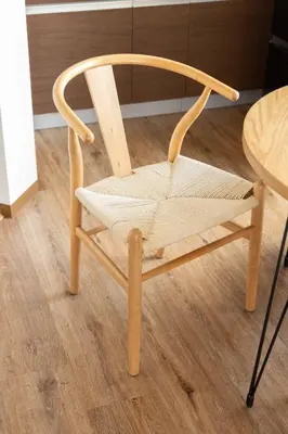 a wooden chair sitting next to a table at Fit-Inn\u7530\u539f\u753a in Tokyo