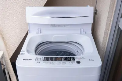 a white washer and dryer in a room at Fit-Inn\u7530\u539f\u753a in Tokyo