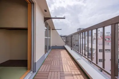 a balcony with a view of a building at Fit-Inn\u7530\u539f\u753a in Tokyo