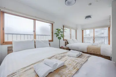 two beds in a room with two windows at Fit-Inn\u7530\u539f\u753a in Tokyo