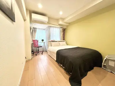a bedroom with a bed and a chair in it at kabukicho 317 SJ0276 in Tokyo