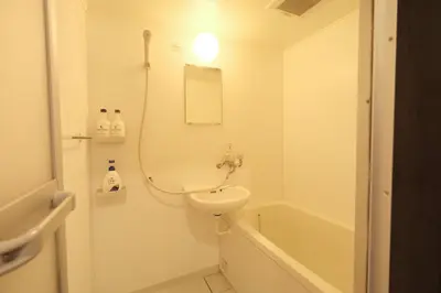 a bathroom with a sink and a toilet and a tub at Urban House Nakano in Tokyo